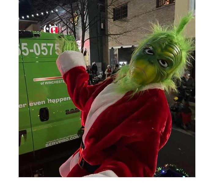Grinch costume wearing a Santa suit 