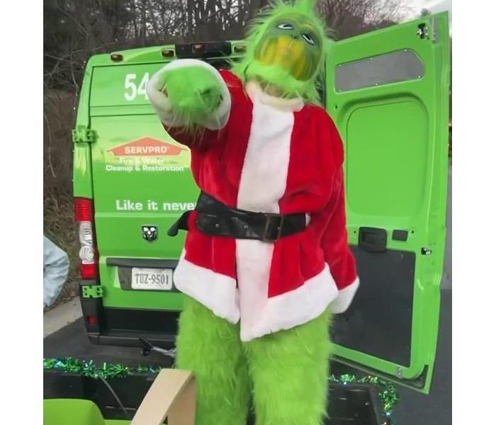 Grinch costume wearing a Santa suit