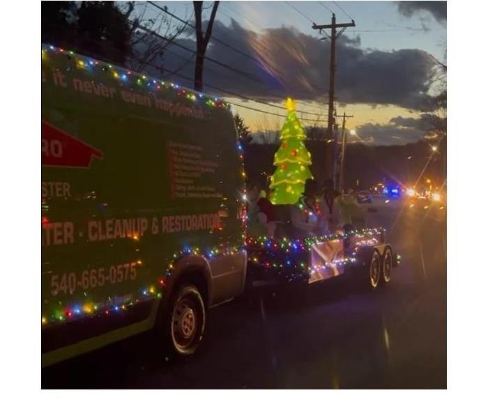 SERVPRO van with holiday decorations and Christmas Lights in the parade
